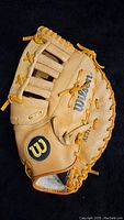 Top view of Wilson A2314 first baseman glove showing palm side and detailed lacing.