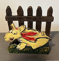 Front view showing the picket fence and cartoon dog design on the napkin holder