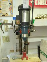 Front view of the full drill press on bench