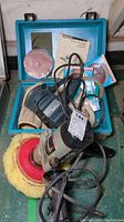 Porter Cable 7 inch polisher with wool buffing pad and Bosch sander/polisher with discs in blue carrying case, including Bosch instruction manual.