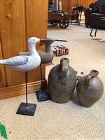All items together: two jugs and two wooden bird decoys on stands