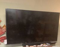 Front view of Samsung 65" TV with soundbar