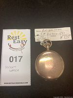 Front view of closed hunter case with engraved pattern and lot tag