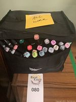 Black carrying case filled with Touch Chenji twin markers shown with marker caps visible on top, featuring assorted colors and a sticky note stating 'All Work'.