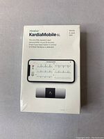 Front view of sealed retail box showing product name, a smartphone display with ECG readout and the device.