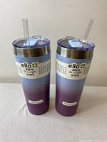 Front view of the two Ello insulated tumblers with lids and straws showing gradient design and branding.