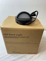 Box labeled 'LED Deck Light 2.5W Waterproof Landscape Light' with 12 pack indicated and some product details.