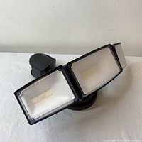 Front view of the CELAVY 70W LED security light showing the three rectangular adjustable LED panels with diffused lenses for outdoor floodlighting.