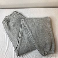 Folded grey Russell Athletic sweatpants showing elastic waistband and overall fabric texture.
