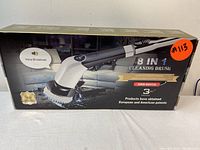 Front of box showing the 8-in-1 electric cleaning brush in white and black with ergonomic handle, digital display and voice broadcast feature.