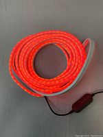 Coiled Monster RGB LED light strip emitting red light, demonstrating functional LED illumination and color vibrancy.