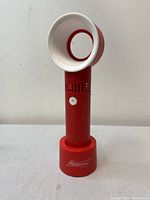 Front view of the portable bladeless fan showing white circular airflow design, red body, and Budweiser branding on the base.