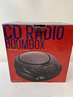 Photo of the original red and blue branded box showing 'CD Radio Boom Box' with Proscan branding and product image.