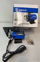Photo of the Deko utility transfer pump with box and accessories showing front and side views of the pump and packaging.