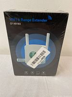 Front view of sealed boxed WiFi 6 Range Extender CF-XR183 showing device image and model number.