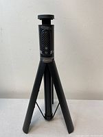 Front view of Atumtek Selfie Stick Tripod standing on its tripod legs showing the phone holder and control panel.