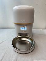 Front view of the YUPOSL automatic pet feeder showing the digital display with a timer and programmable functions, stainless steel bowl attached