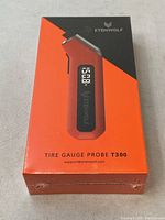 Box of Etenwolf Tire Gauge Probe T300 in orange and black design with product name and branding visible.