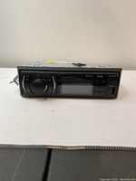 Front view of Boss Audio Systems 616UAB car stereo showing LED display, control buttons, and a large volume knob.