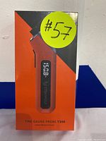 Front view of box showing Tire Gauge Probe T300 device image in orange and black packaging with a digital readout display.
