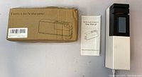 Electric Knife Sharpener in original cardboard box with user manual and sharpener unit, shown from top view.