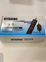Top-view of the boxed HITAUING Intelligent Aquarium Heater showing branding, product image, and technology info.