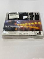 Front view of unopened BtFarm LED Fairy Light Set in original sealed plastic packaging showing branding, model SL21, and information labels.