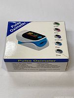 Box front showing image of the pulse oximeter device and various color screen options
