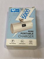 Box showing the mini portable charger with 500mAh battery capacity, highlighting fast charging, digital display and mini size features.