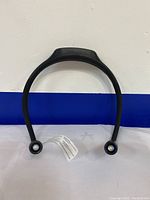 Front view of the black flexible band style reading light, showing the two circular LED light heads and the overall design.