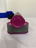 Front circular magenta end of dry iron showing brand name 'Trivoly Myself'