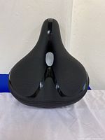 Top view of black Reruia bicycle saddle showing central cut-out and textured seating area.