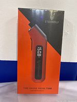 Front view of the packaging showing Etenwolf Tire Gauge Probe T300 in red and black with digital display on box.