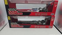 Two boxed Racing Champions 1:24 scale diecast Top Fuel dragsters, one red/white Carquest and one black