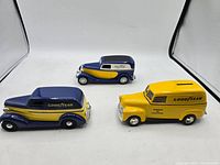 Set of three Goodyear diecast coin banks together showing size and style.