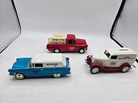 Front angled view of all three Wix Filters branded diecast coin bank vehicles on white background.
