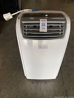 Front view of Black & Decker portable air conditioner with MaxSold auction tag