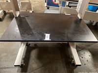 Top view of the black work surface of the technical workstation showing size and condition.