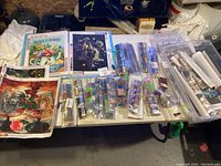 Wide view of diamond art canvases laid on table with multiple packs of diamond drills and tools