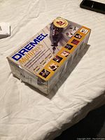 Boxed Dremel MultiPro 5 rotary tool kit rotated showing front with branding and warranty label