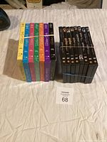 Photo showing 7 complete DVD boxed sets of The Golden Girls seasons 1 through 7 in colorful packaging, along with 8 Harry Potter DVD movies in black cases bundled separately.