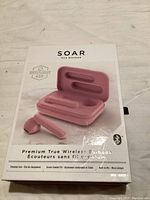 Front photo of original box for SOAR Premium True Wireless Earbuds showing the pink earbuds and charging case pictured on the packaging.