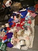 Overview of large assortment of fabric pieces and sewing materials laid out on a white backdrop.