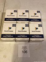 Six boxes of Pencil Buddies Triangle Shaped Golf Pencils in original sealed packaging, showing branding and quantity.