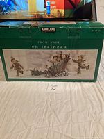 Photo of boxed Kirkland Winter Sleigh Ride porcelain figurine set showing front side with product image and branding.