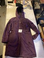 Full view of the purple hooded jacket showing front, pockets, and hood.