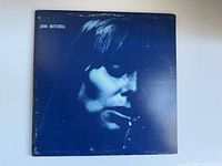 Front cover of the Joni Mitchell Blue vinyl album showing blue monochrome photo of Joni Mitchell with wear and scuffs.