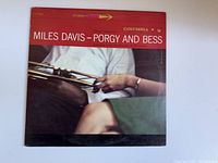 Front cover image of the Miles Davis Porgy and Bess album featuring a trumpet and hands with detailed condition showing wear.