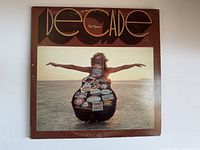Front cover of Neil Young's "Decade" vinyl album showing person with outstretched arms and album title