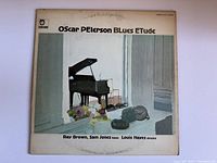 Front cover of the Oscar Peterson Blues Etude vinyl record showing piano painting and artist/musician credits.